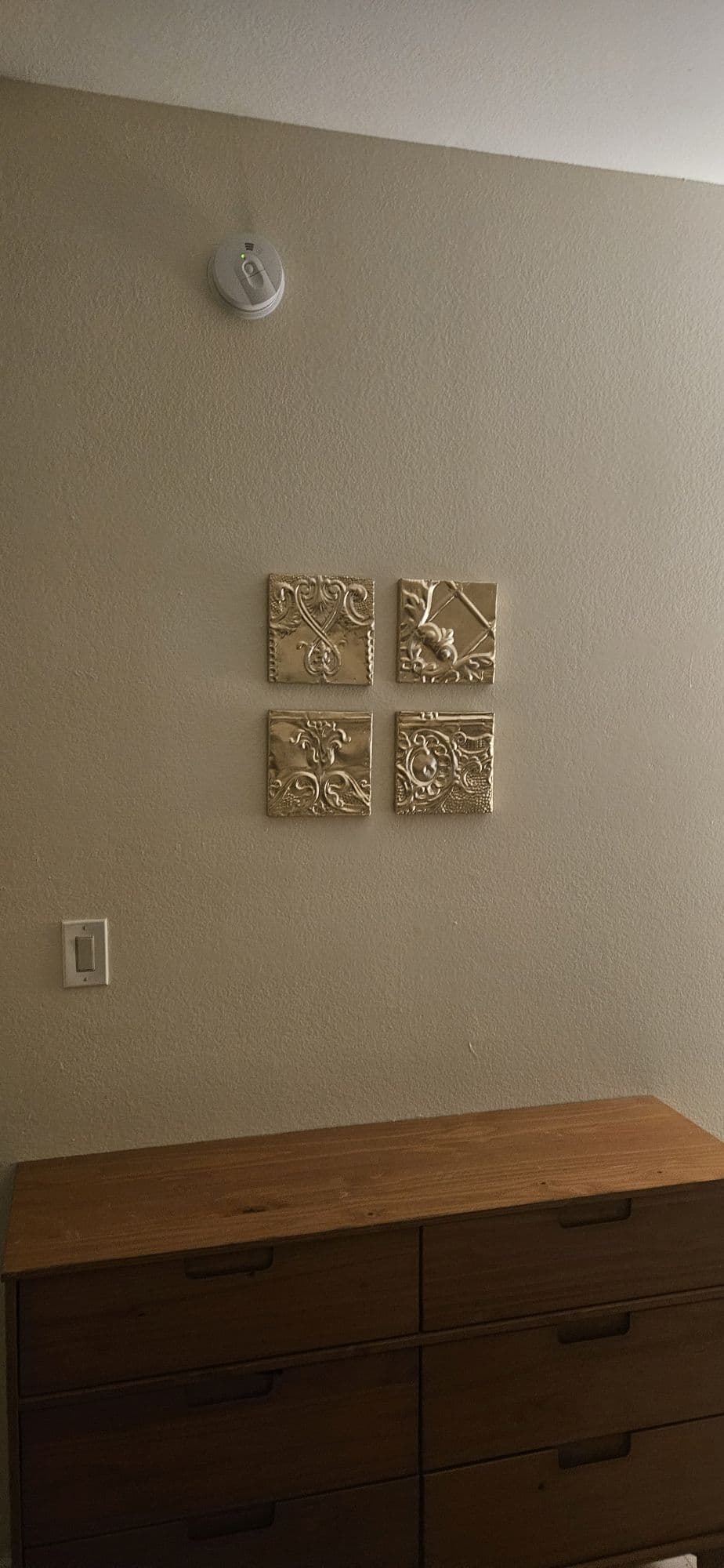 Small framed art pieces aligned on wall