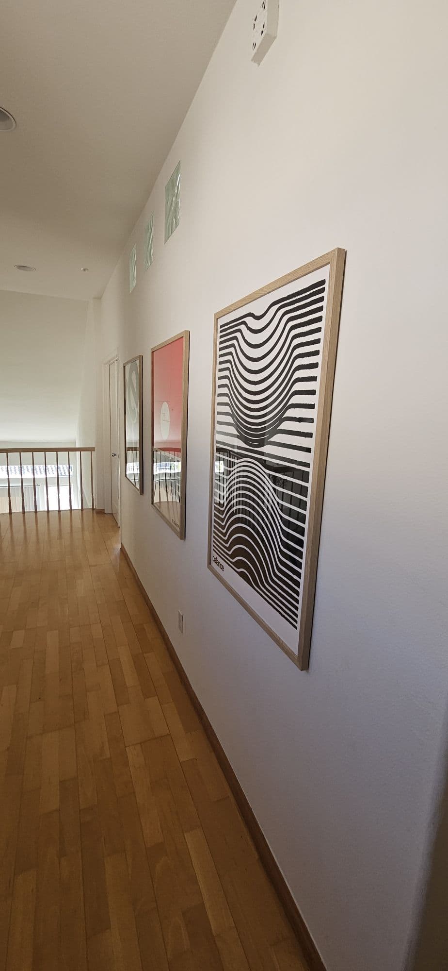 Wall with multiple art pieces aligned in a gallery layout